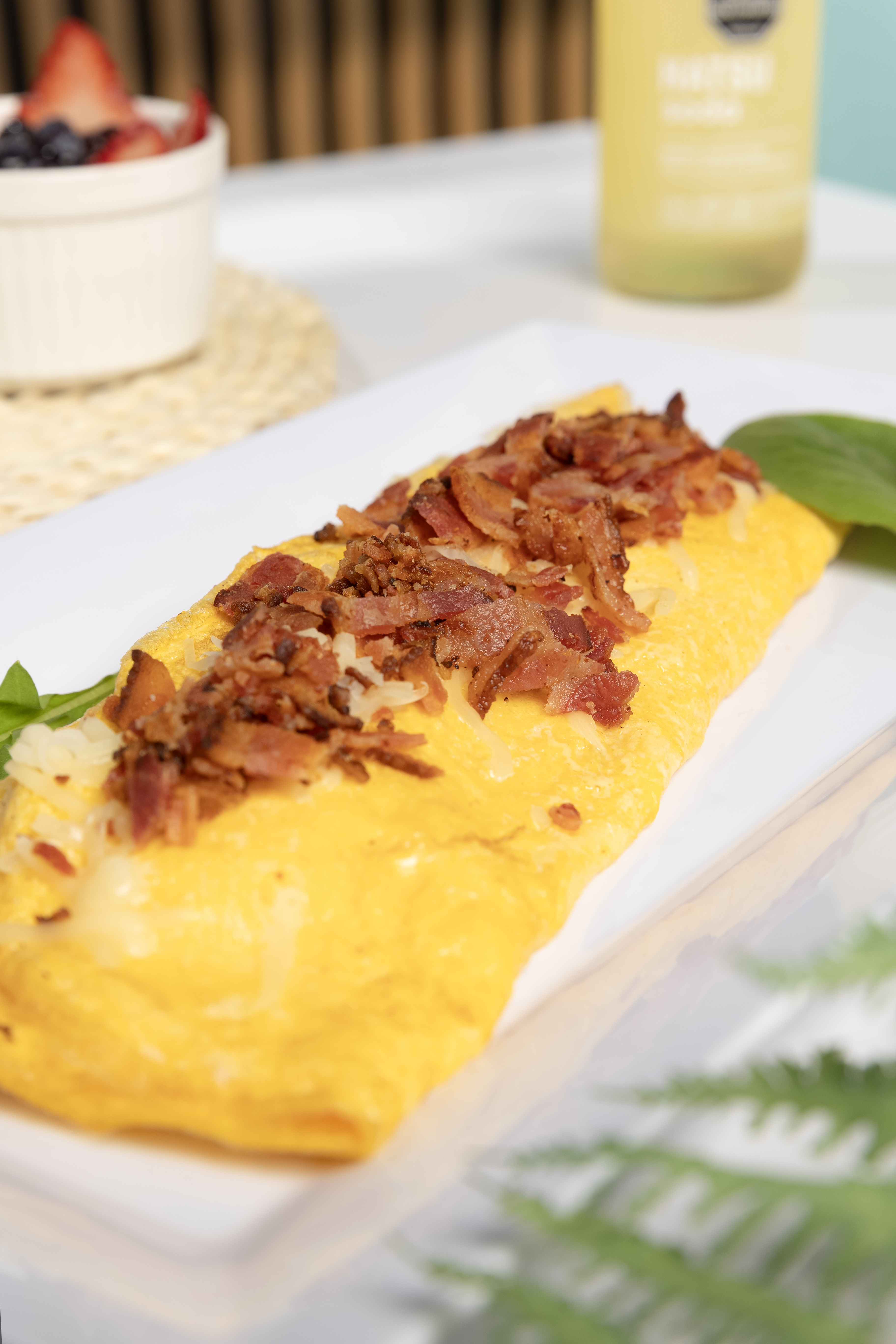 Desayuno completo con waffles y frutos rojos en TROPICO